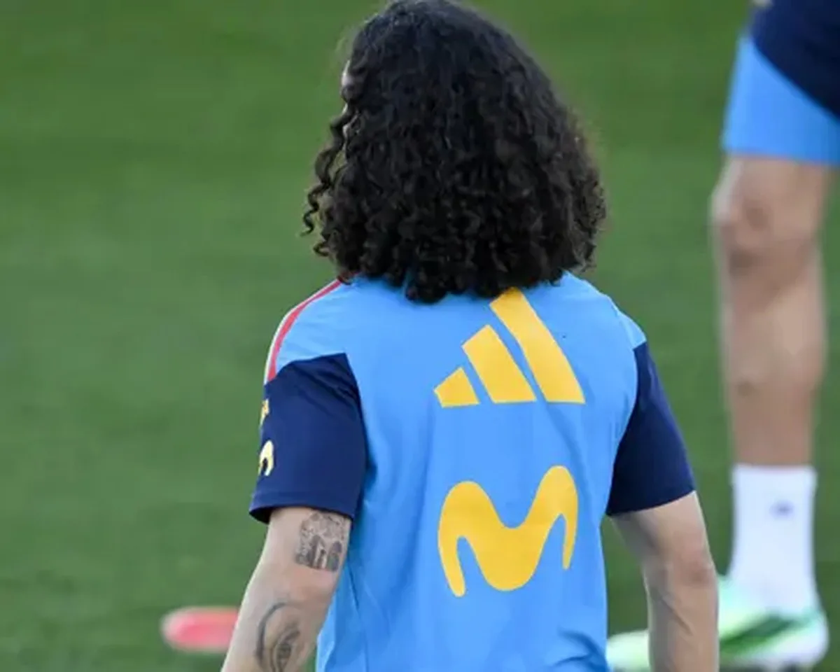 A photo from behind of the Spain defender Marc Cucurella during team training, which shows on the back of his left arm a tattoo of the team’s head coach, Luis de la Fuente