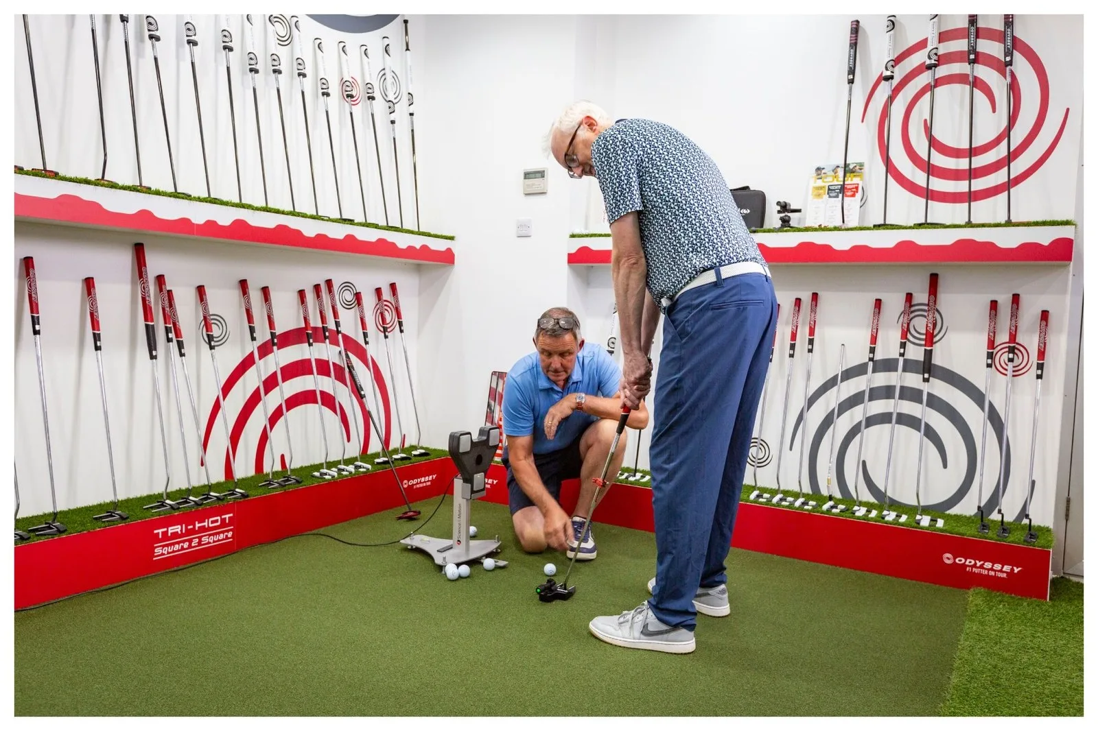A male golfer being fitted for an Odyssey putter