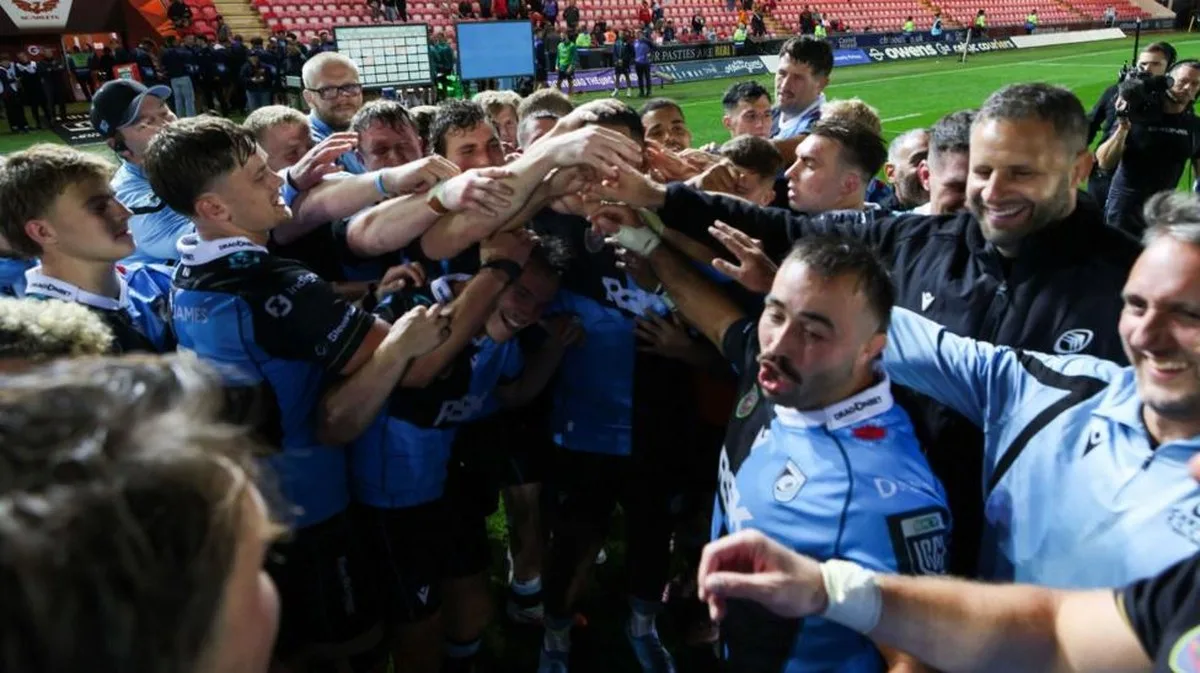 Cardiff squad in a celebration huddle after beating Scarlets
