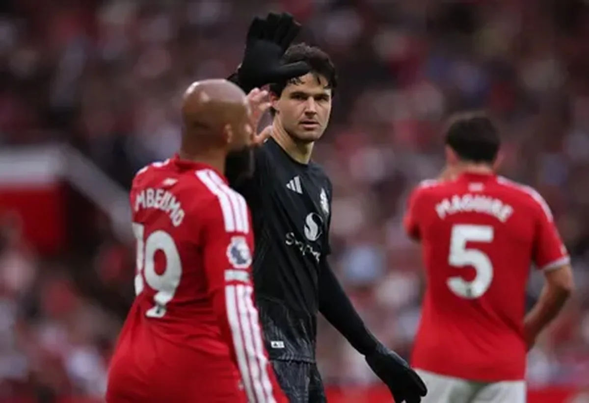 Senne Lammens high-fives Bryan Mbeumo on the pitch