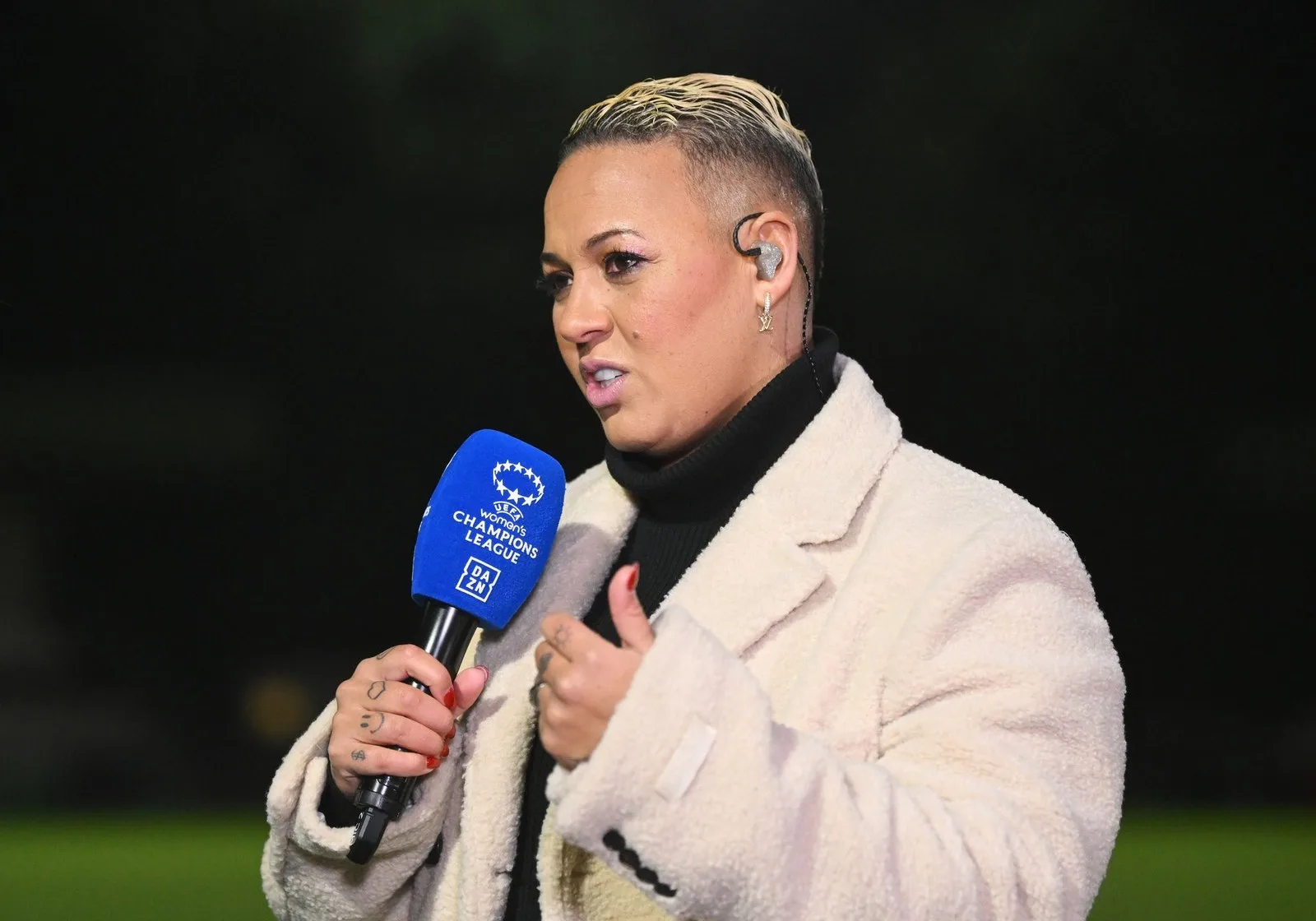 BOREHAMWOOD, ENGLAND - DECEMBER 18: Lianne Sanderson, former Arsenal player looks on whilst working pitchside for broadcaster DAZN after the UEFA Women's Champions League match between Arsenal FC and FC Bayern München at Meadow Park on December 18, 2024 in Borehamwood, England. 