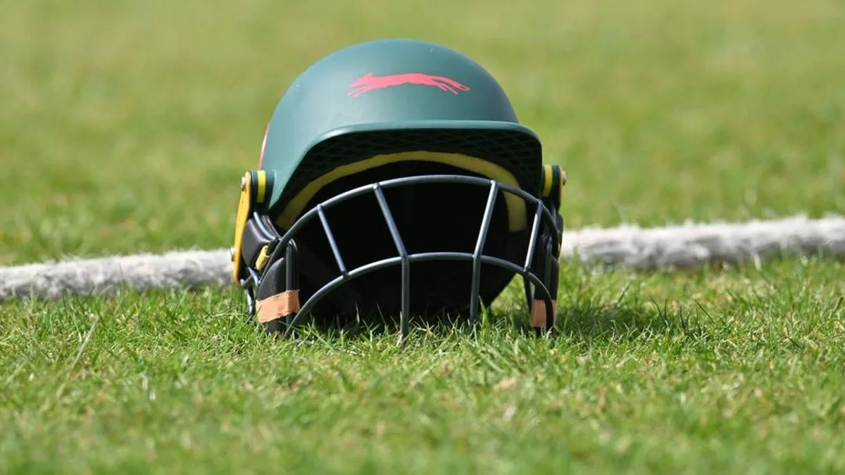 A green Leicestershire helmet placed by a boundary rope