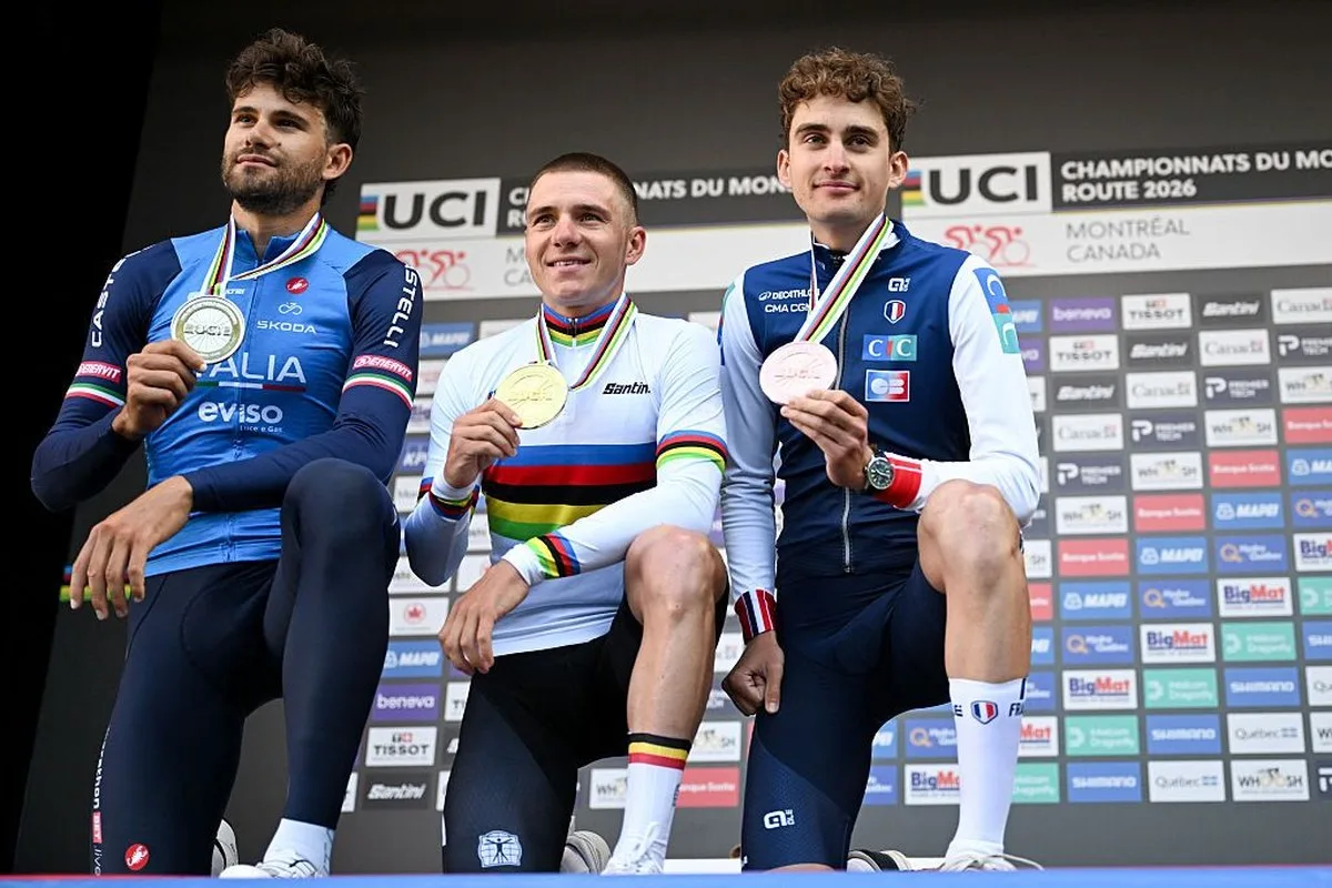 (L/R) Second place finisher Filippo Ganna of Italy , first place finisher Remco Evenepoel of Belgium and third place finisher Paul Seixas of France celebrate on the podium after the Men's Elite individual time trial at the 2026 Union Cycliste Internationale (UCI) Road World Championships in Montreal, Quebec, on September 20, 2026. (Photo by Andrej Ivanov / AFP)