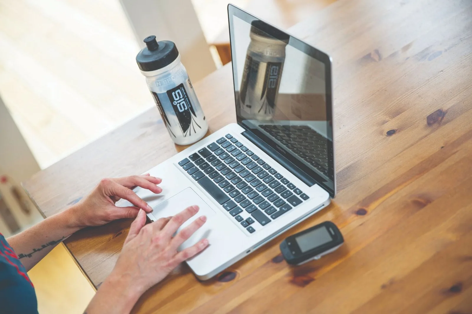 Image shows a rider looking at a laptop.