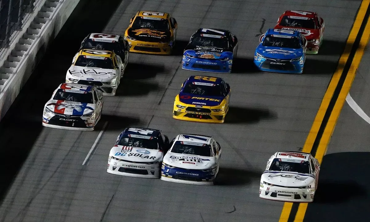 Justin Haley, Elliott Sadler, and Kyle Larson battle for the win