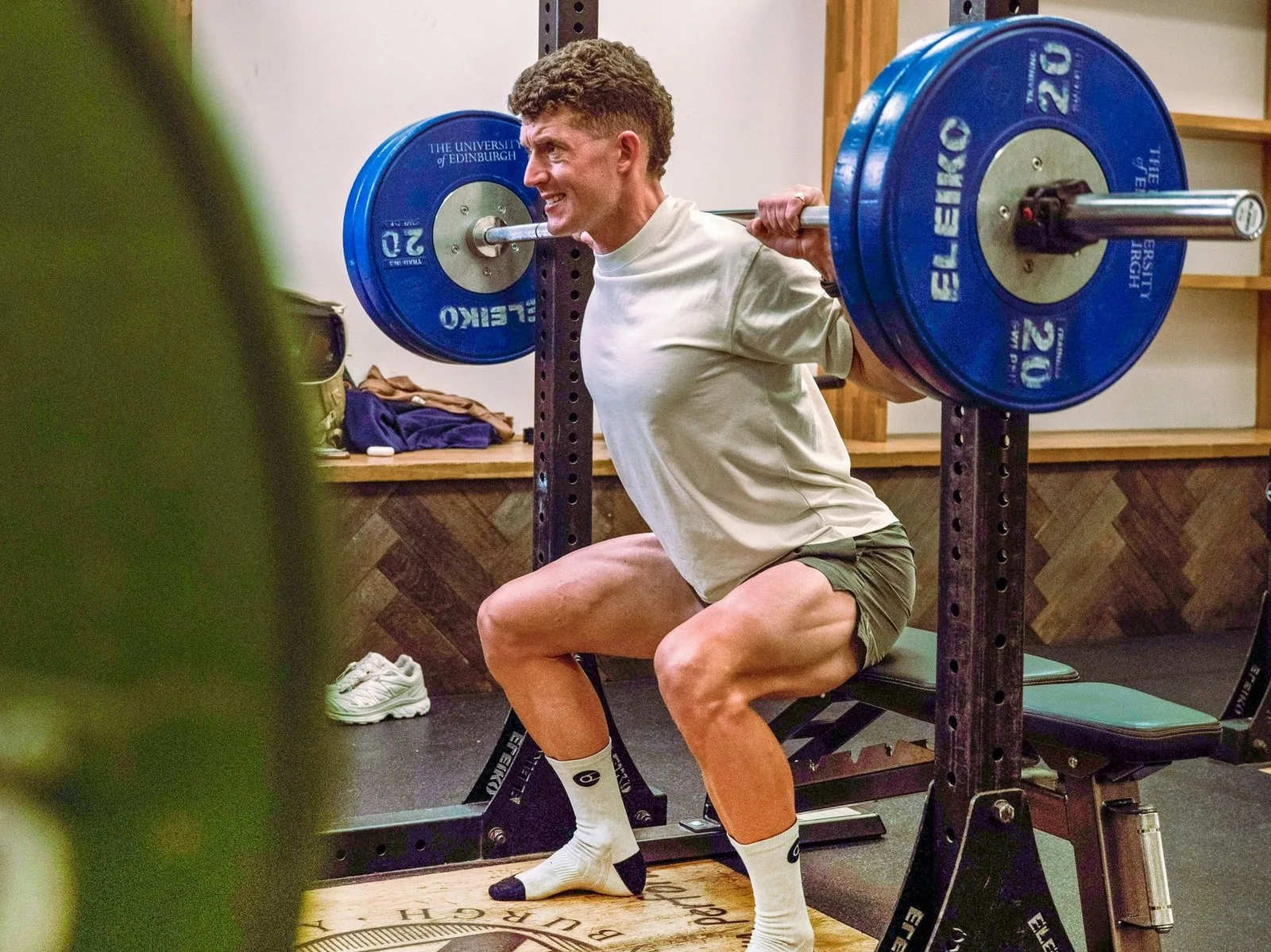 Cyclist squatting in the gym