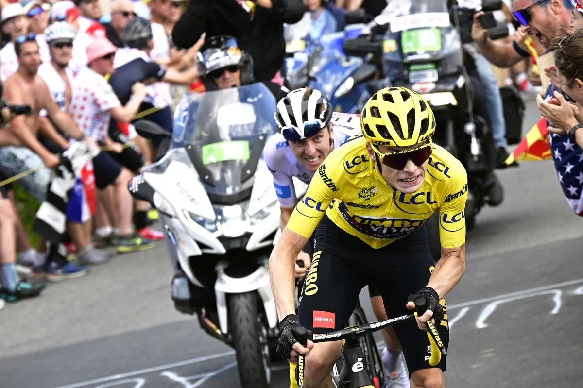 MORZINE LES PORTES DU SOLEIL, FRANCE - JULY 15: (L-R) Tadej Pogacar of Slovenia and UAE Team Emirates - White best young jersey and Jonas Vingegaard of Denmark and Team Jumbo-Visma - Yellow leader jersey compete in the breakaway while fans cheers during the stage fourteen of the 110th Tour de France 2023 a 151.8km stage from Annemasse to Morzine les Portes du Soleil / #UCIWT / on July 15, 2023 in Morzine les Portes du Soleil, France. (Photo by Bernard Papon - Pool/Getty Images)