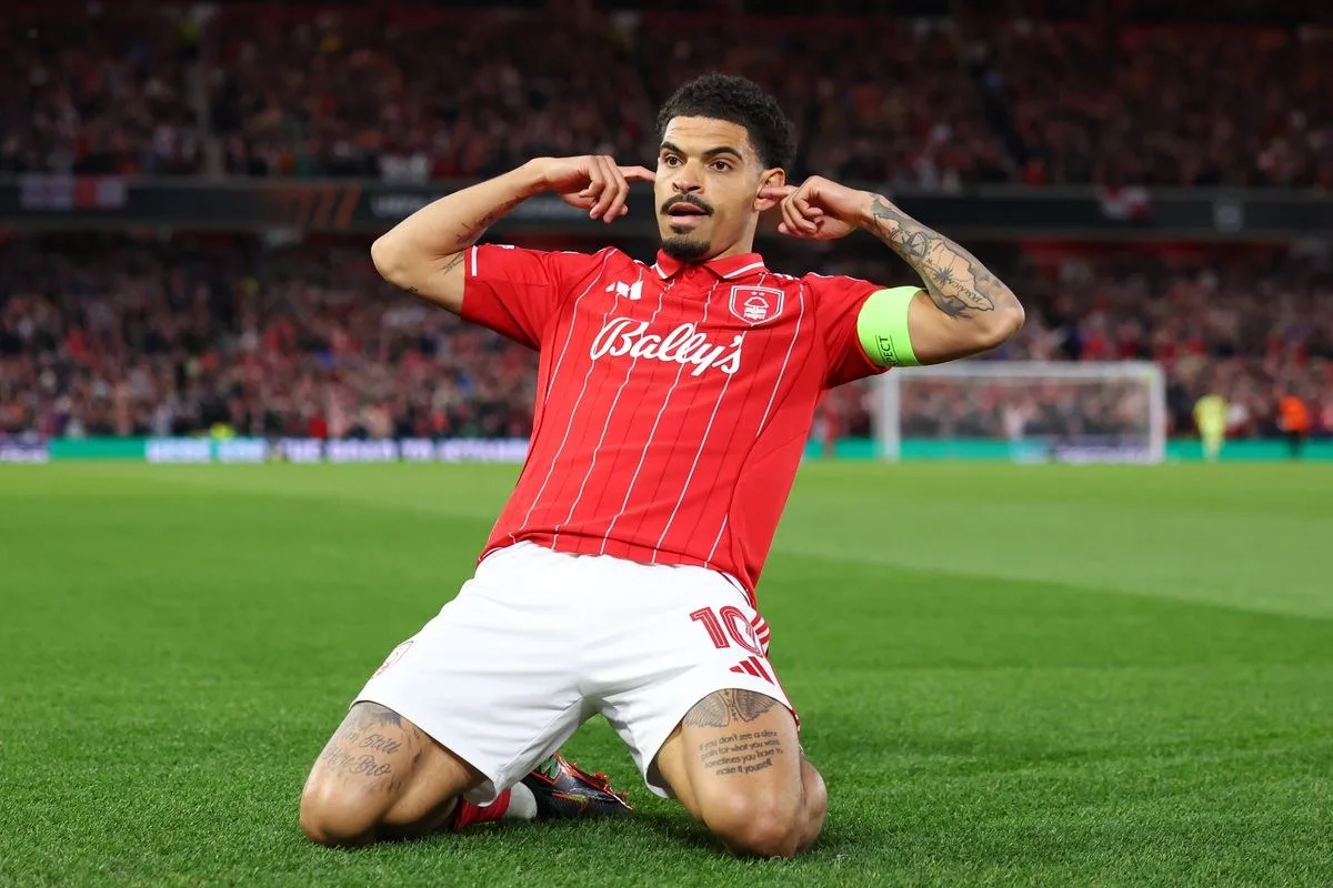 Nottingham Forest midfielder Morgan Gibbs-White knee-sliding, fingers in his ears.