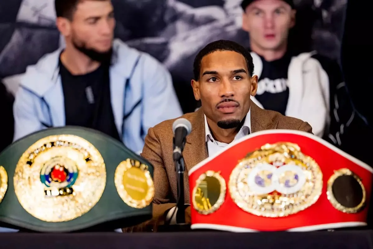 Osleys Iglesias sits with his IBF and IBO championship belts during the press conference